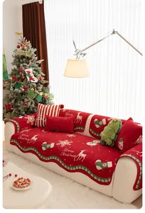 Detail of red Christmas chenille sofa cover featuring white reindeer and snowflake patterns