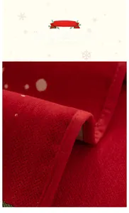 Detailed view of red Christmas chenille sofa cover with herringbone weave and hemmed edges