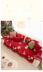 Detail of red Christmas chenille sofa cover with reindeer and snowflake patterns