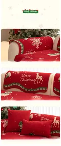 Detail of red Christmas chenille sofa cover with reindeer and snowflake patterns