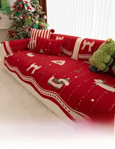 Detail of red Christmas chenille sofa cover with bow and festive pattern