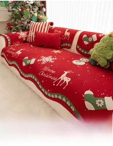 Detail of red Christmas chenille sofa cover featuring reindeer and snowflake knit texture