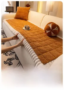 Close-up of caramel fleece sofa cover featuring quilted squares and white ruffled edges