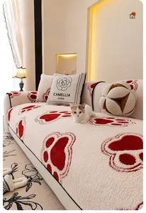 Close-up of thick plush fleece sofa cover with red cat paw prints and camellia pillow
