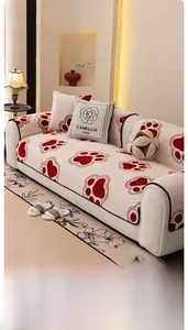 Close-up of soft cream plush sofa cover featuring red paw prints and camellia pillow detail
