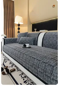 Detail of grey checkered thick fleece sofa cover with matching pillows and warm texture