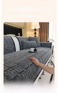 Detail of grey checkerboard jacquard sofa cover made of thick and soft fleece fabric