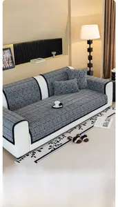 Close-up of thick grey checkered sofa cover with black edge binding and matching pillows