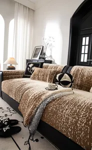 Detail of plush brown velvet sofa cover with embroidery pillow in luxury living room