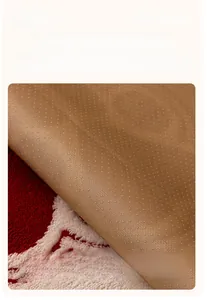 Macro shot of non-slip silicone backing on thick plush red sofa cover protector