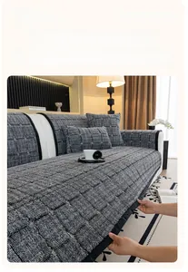 Detail of gray waffle texture sofa cover and matching pillows in a modern living room