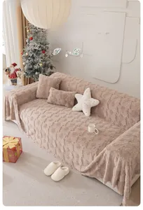 Close-up of thick plush beige sofa cover featuring embossed Christmas tree patterns