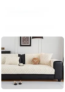 Detail of cream plush sofa cover with 3D wave texture and black piping decoration
