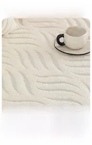 Detailed close-up of cream soft cotton velvet sofa cover with embossed leaf textures