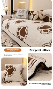 Close-up of soft plush sofa cover featuring brown dog paw patterns and floral embroidery