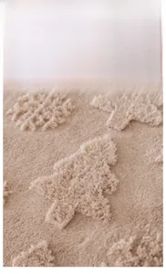 Close-up of warm camel rabbit fur sofa cover with embossed Christmas trees and snowflakes