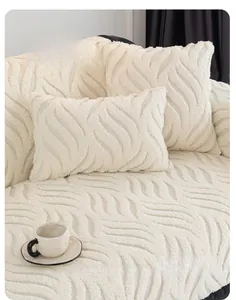 Detailed view of the wavy plush texture on a cream-colored thick sofa cover and cushion