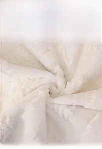 Macro detail of thick cream rabbit faux fur sofa cover with soft plush texture