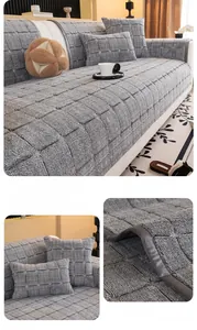 Detail of light gray quilted sofa cover showing thick plush fabric and stitching texture