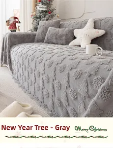 Close-up of grey plush Christmas sofa cover with embossed tree patterns and festive pillows