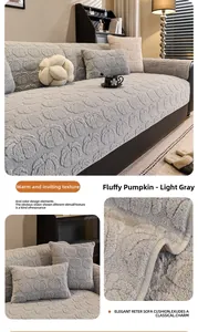 Macro detail of plush pumpkin texture and neat stitching on light gray sofa cushion