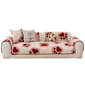 Plush non-slip sofa cover with red paw prints and decorative floral throw pillows