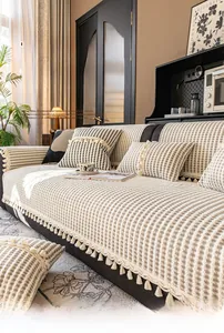 Detail of milk velvet sofa pad with elegant stripes and decorative tassel edges