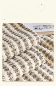 Close-up of thick plush velvet sofa cover with houndstooth texture and wide hem design