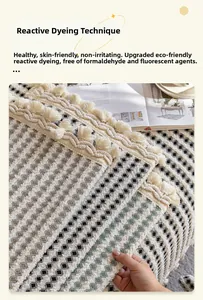 Detail of bohemian sofa cover with eco-friendly reactive printing and woven tassels
