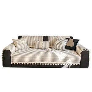Thick checkered plush sofa cover set with decorative white pom-pom fringe details