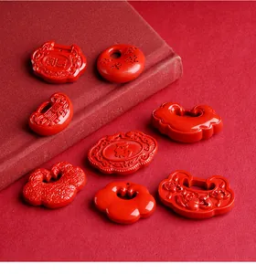 Detailed close-up of natural red cinnabar talismans with traditional Chinese luck symbols