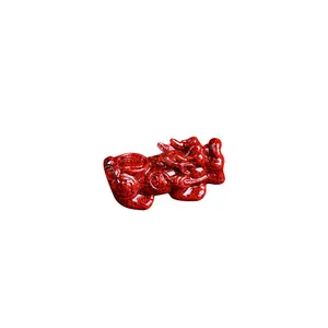 Natural cinnabar Pixiu sculpture figurine with intricate red texture on white background