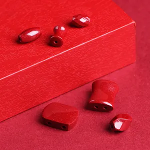 Natural cinnabar crystal beads in various shapes for jewelry making on red gift box