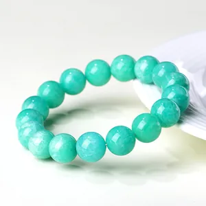 Natural amazonite round bead bracelet with polished blue-green stones on white background