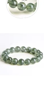 Macro detail of 7A grade green rutilated quartz bracelet with clear needle inclusions