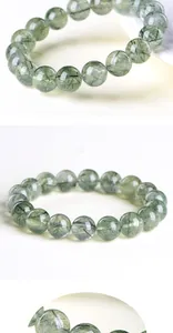 Macro detail of natural green rutilated quartz beads with visible needle-like inclusions