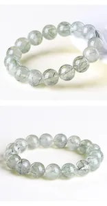 Macro shot of natural green rutilated quartz beads with crystal clear texture and inclusions