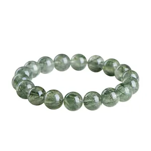 Natural green rutilated quartz bead bracelet featuring clear crystals and green inclusions