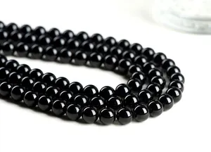 Macro shot of high-polished natural black tourmaline beads for DIY jewelry making