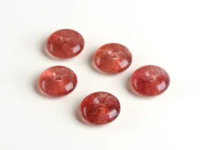 Macro shot of five translucent pink strawberry quartz pendants with natural textures