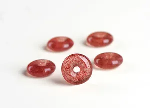 Detailed view of natural strawberry quartz donut charms with unique mineral inclusions