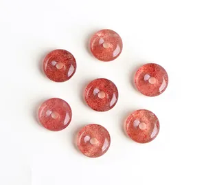 Macro shot of seven natural strawberry quartz donut charms with red mineral textures