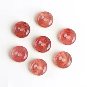 Natural strawberry quartz donut pendants with red mineral inclusions on white background