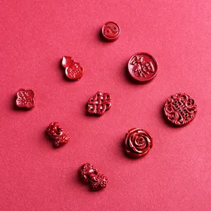 Carved red cinnabar cinnabar stone beads featuring traditional Chinese lucky charms and flowers