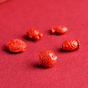 Five red cinnabar fish-shaped beads with detailed scales for DIY jewelry making