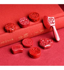 Detailed close-up of red cinnabar axe charm and Fu character beads for jewelry making