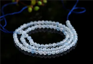 Macro detail of faceted natural aquamarine beads with sparkling light reflections