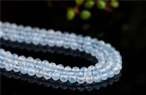 Macro shot of 4-6mm faceted blue aquamarine beads with translucent icy texture