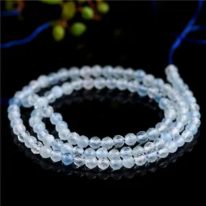 Faceted natural aquamarine beads in light blue with reflective mirror background
