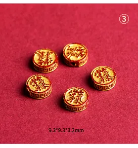 Macro detail of cinnabar pattern beads with gold Chinese fortune symbols and retro design